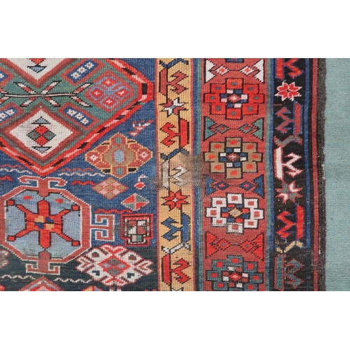 2143 - A DARK BLUE GROUND CAUCASIAN RUNNER with four multicoloured diamond medallions and multicoloure... 