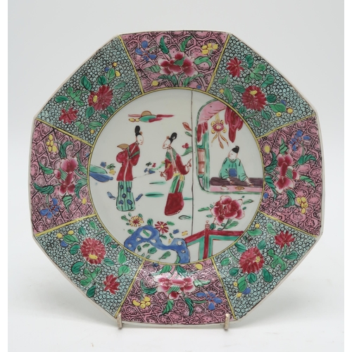 2304 - A CHINESE FAMILLE ROSE EXPORT OCTAGONAL PLATE Painted with three figures within elaborate foliate bo... 