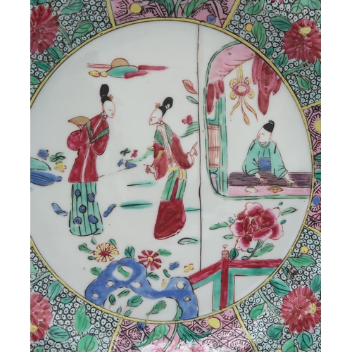 2304 - A CHINESE FAMILLE ROSE EXPORT OCTAGONAL PLATE Painted with three figures within elaborate foliate bo... 