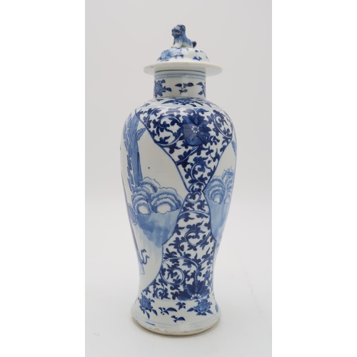 2309 - A CHINESE BLUE AND WHITE BALUSTER VASE AND COVER painted with figures in panels within scrolling fol... 