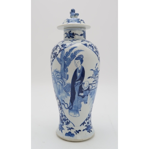 2309 - A CHINESE BLUE AND WHITE BALUSTER VASE AND COVER painted with figures in panels within scrolling fol... 