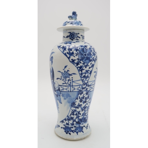 2309 - A CHINESE BLUE AND WHITE BALUSTER VASE AND COVER painted with figures in panels within scrolling fol... 