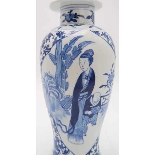 2309 - A CHINESE BLUE AND WHITE BALUSTER VASE AND COVER painted with figures in panels within scrolling fol... 