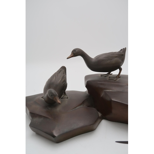 2321 - A JAPANESE BRONZE MODEL OF TWO DUCKSstanding on rockwork, 17cm high and 39cm wide... 