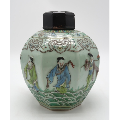 2325 - A CHINESE CELADON GROUND OCTAGONAL JAR AND COVER moulded in relief with figures on waves and beneath... 