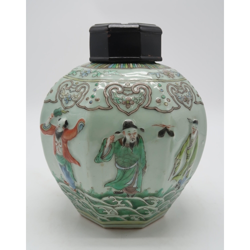 2325 - A CHINESE CELADON GROUND OCTAGONAL JAR AND COVER moulded in relief with figures on waves and beneath... 