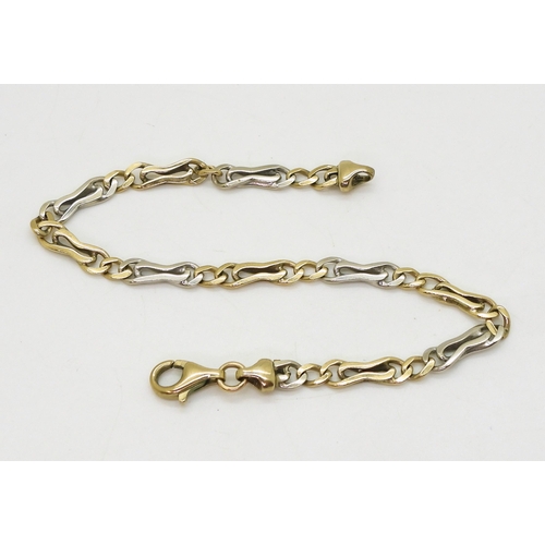 2704 - A YELLOW AND WHITE GOLD BRACELETstamped 375 to the clasp and chain end, with alternated fancy links ... 