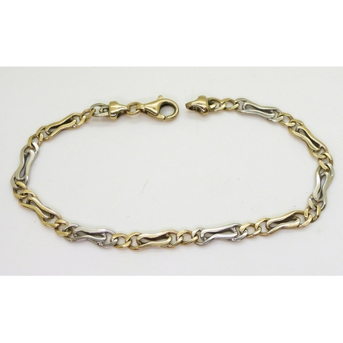 2704 - A YELLOW AND WHITE GOLD BRACELETstamped 375 to the clasp and chain end, with alternated fancy links ... 
