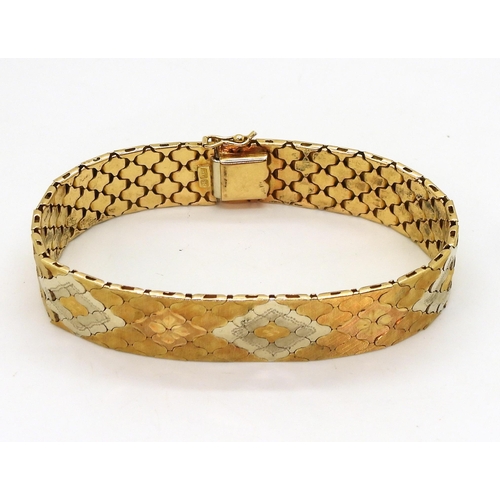 2710 - A THREE COLOUR GOLD BRACELETItalian made, stamped 750, with engraved flower pattern to the interlock... 