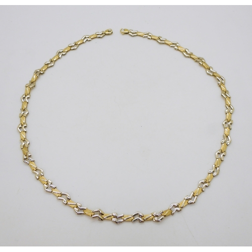 2712 - AN ITALIAN MADE CHAINwith 18ct gold Italian hallmarks, the abstract links are in yellow and white go... 