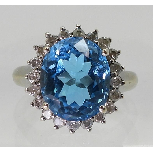 2718 - A BLUE TOPAZ & DIAMOND CLUSTER RINGset in 9ct white gold, the central topaz approx 12mm x 10mm, ... 