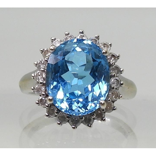 2718 - A BLUE TOPAZ & DIAMOND CLUSTER RINGset in 9ct white gold, the central topaz approx 12mm x 10mm, ... 