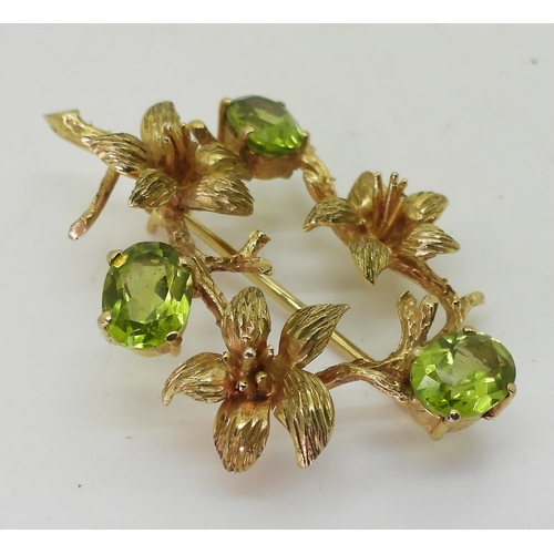2723 - TWO VINTAGE BROOCHESa 9ct gold lily flower and peridot brooch, hallmarked London 1973, made by Cropp... 
