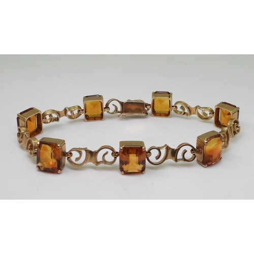 2730 - A CITRINE BRACELETmounted in 9ct gold with pretty scroll shaped links, each citrine is approx 10mm x... 