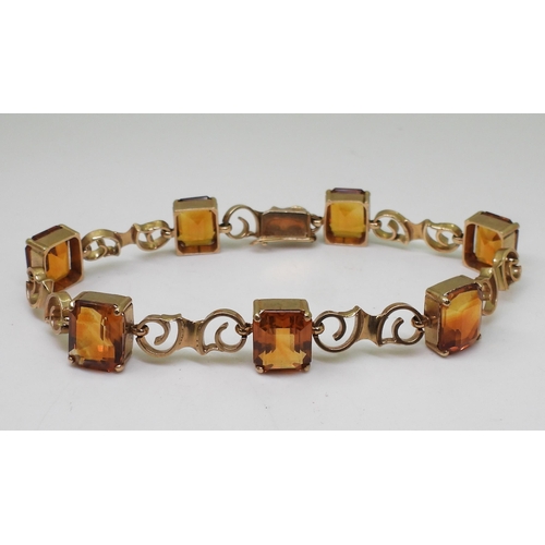 2730 - A CITRINE BRACELETmounted in 9ct gold with pretty scroll shaped links, each citrine is approx 10mm x... 