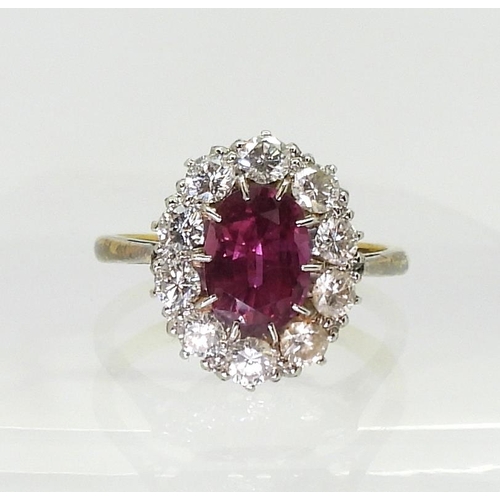 2737 - AN 18CT GOLD RINGset with an oval pink gem, surrounded with 0.80cts of brilliant cut diamonds, to th... 