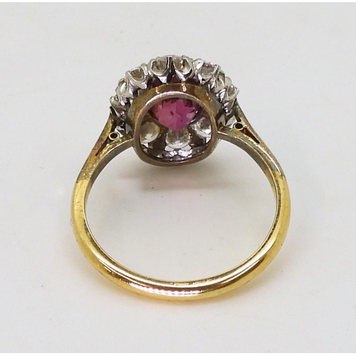 2737 - AN 18CT GOLD RINGset with an oval pink gem, surrounded with 0.80cts of brilliant cut diamonds, to th... 