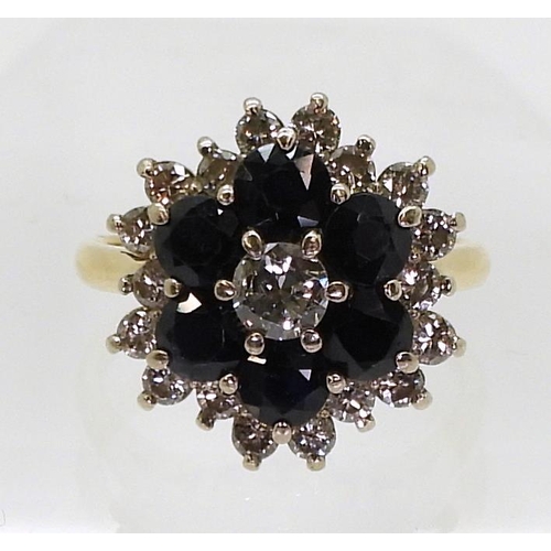 2743 - A SAPPHIRE & DIAMOND CLUSTER RINGmounted in 18ct yellow gold the classic flower formation is set... 