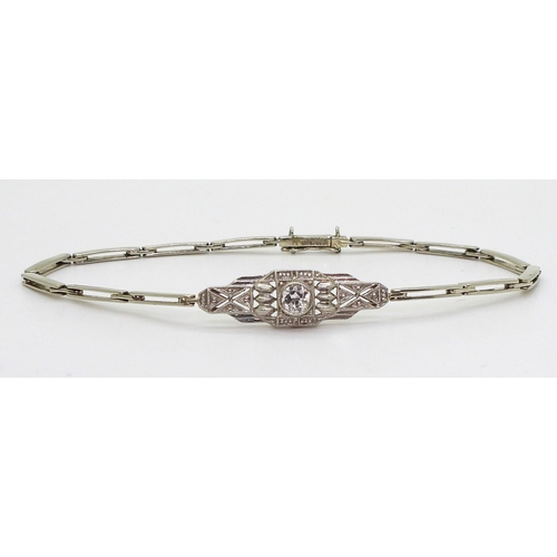 2760 - A DIAMOND ART DECO BRACELETthe white metal central pierced panel is set with a 0.20ct brilliant cut ... 