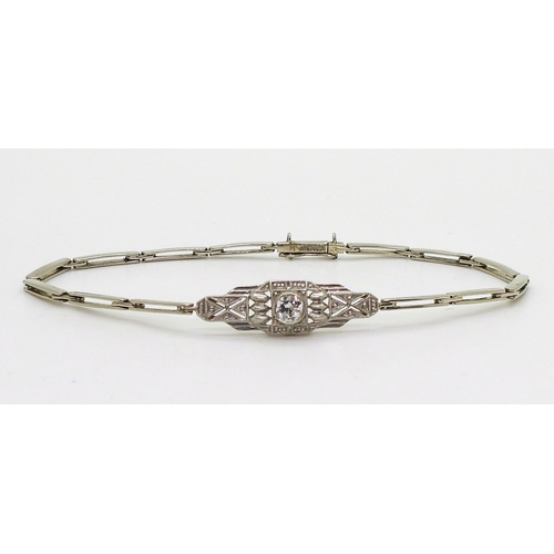 2760 - A DIAMOND ART DECO BRACELETthe white metal central pierced panel is set with a 0.20ct brilliant cut ... 