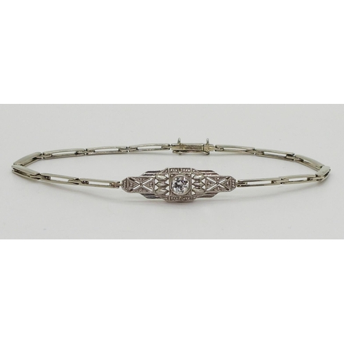 2760 - A DIAMOND ART DECO BRACELETthe white metal central pierced panel is set with a 0.20ct brilliant cut ... 