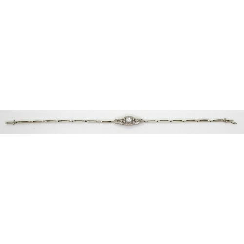 2760 - A DIAMOND ART DECO BRACELETthe white metal central pierced panel is set with a 0.20ct brilliant cut ... 