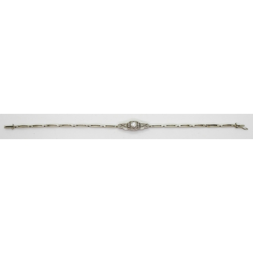 2760 - A DIAMOND ART DECO BRACELETthe white metal central pierced panel is set with a 0.20ct brilliant cut ... 