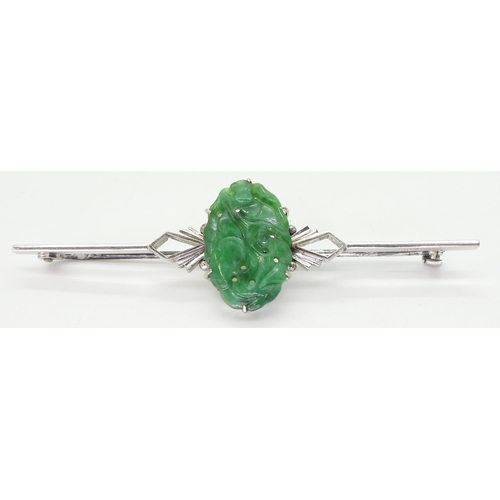 2768 - A CHINESE GREEN HARDSTONE BROOCHin a 9ct white gold Art Deco style mount, the hardstone carved with ... 