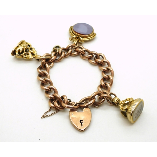 2769 - A CURB CHAIN BRACELETin 9ct rose gold of hollow construction, with three attached fob seals, a 9ct b... 