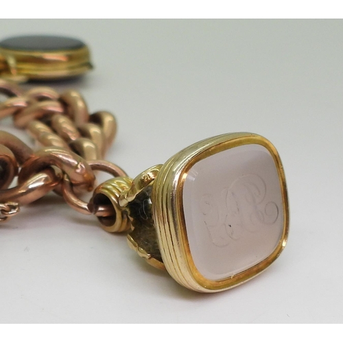 2769 - A CURB CHAIN BRACELETin 9ct rose gold of hollow construction, with three attached fob seals, a 9ct b... 