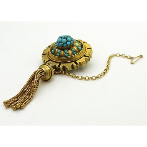 2770 - A VICTORIAN TURQUOISE BROOCHstamped 15ct, with domed locket back and tassel. diameter 3.3cm diameter... 