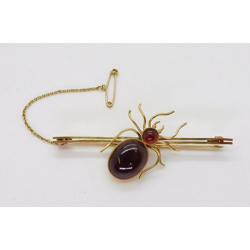 2777 - A SPIDER BROOCHmounted in 9ct gold with garnets the largest approx 14.5mm x 11mm, length of brooch 6... 