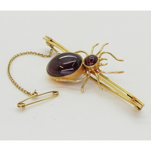 2777 - A SPIDER BROOCHmounted in 9ct gold with garnets the largest approx 14.5mm x 11mm, length of brooch 6... 