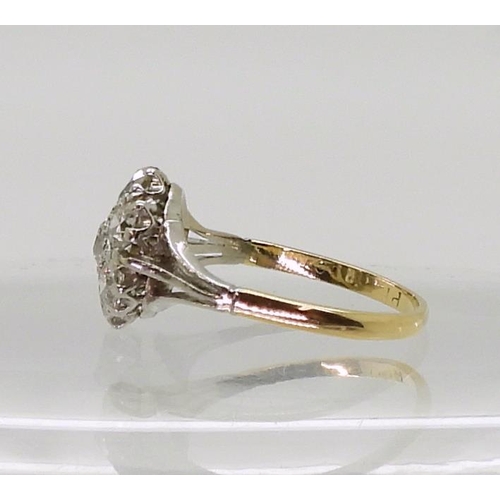 2778 - AN 18CT GOLD AND PLATINUM DIAMOND FLOWER RING with fleur de lis shoulders, set with estimated approx... 