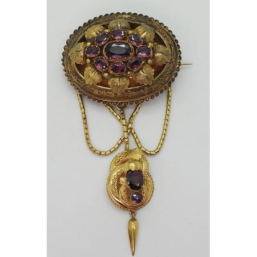 2782 - A VICTORIAN LOCKET BACK BROOCHmade in bright yellow metal, set with foiled back garnets to the centr... 