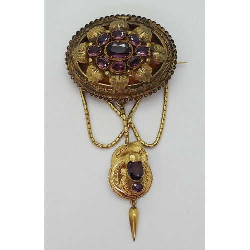 2782 - A VICTORIAN LOCKET BACK BROOCHmade in bright yellow metal, set with foiled back garnets to the centr... 