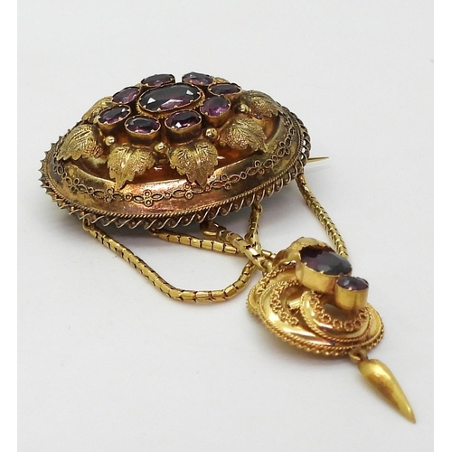 2782 - A VICTORIAN LOCKET BACK BROOCHmade in bright yellow metal, set with foiled back garnets to the centr... 