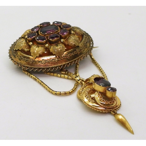 2782 - A VICTORIAN LOCKET BACK BROOCHmade in bright yellow metal, set with foiled back garnets to the centr... 