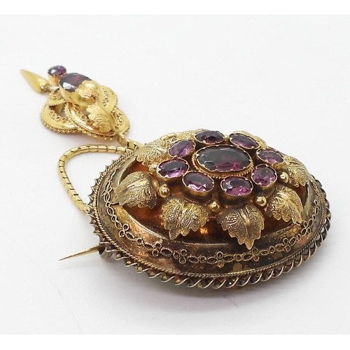 2782 - A VICTORIAN LOCKET BACK BROOCHmade in bright yellow metal, set with foiled back garnets to the centr... 