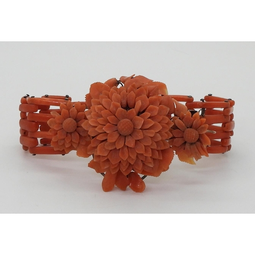 2783 - A VINTAGE CORAL BRACELETwith central flower motif, made from carved coral petals (some losses) with ... 