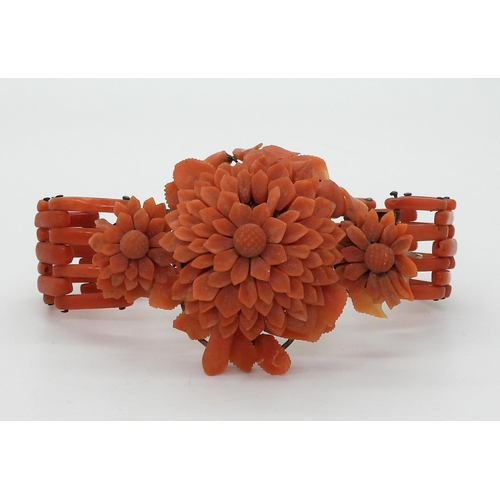 2783 - A VINTAGE CORAL BRACELETwith central flower motif, made from carved coral petals (some losses) with ... 