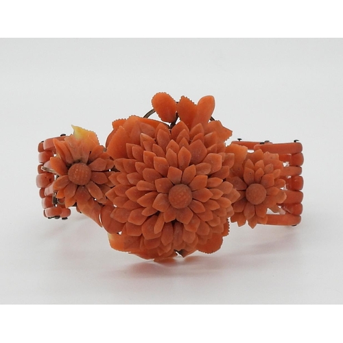 2783 - A VINTAGE CORAL BRACELETwith central flower motif, made from carved coral petals (some losses) with ... 