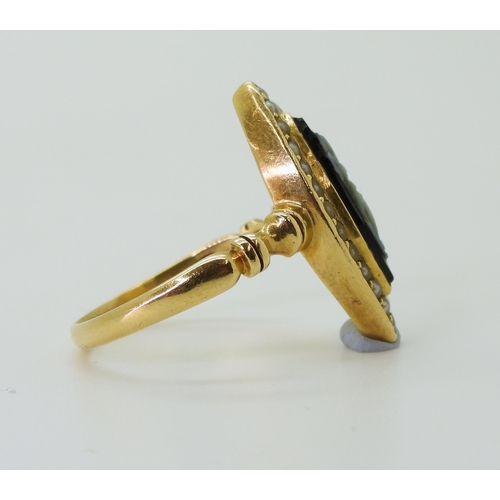 2784 - A MOURNING RINGof marquis shape, made in 18ct gold, set with a black and white gem cameo carved with... 