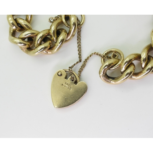 2789 - A SOLID GOLD BRACELETmade in 9ct yellow gold the heavy curb chain is secured with a heart shaped cla... 