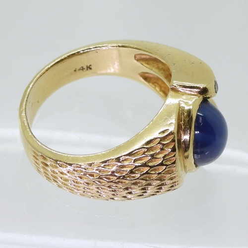 2793 - A 14K GOLD GENTS RINGset with a synthetic star sapphire and diamond accents, finger size R1/2, weigh... 