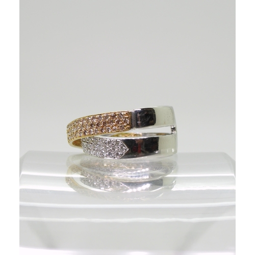 2794 - A STYLISH TWIST DIAMOND RINGmade in 18ct yellow and white gold and set with champagne and white diam... 