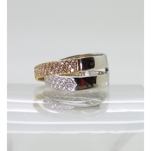 2794 - A STYLISH TWIST DIAMOND RINGmade in 18ct yellow and white gold and set with champagne and white diam... 