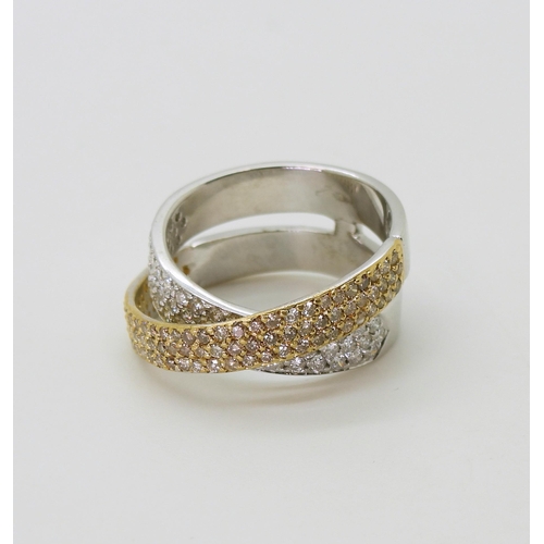 2794 - A STYLISH TWIST DIAMOND RINGmade in 18ct yellow and white gold and set with champagne and white diam... 