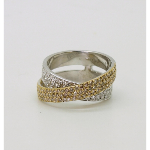 2794 - A STYLISH TWIST DIAMOND RINGmade in 18ct yellow and white gold and set with champagne and white diam... 