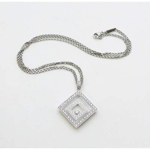 2795 - A CHOPARD HAPPY-SPIRIT PENDANTin 18ct white gold, the square pendant has two diamond set free floati... 